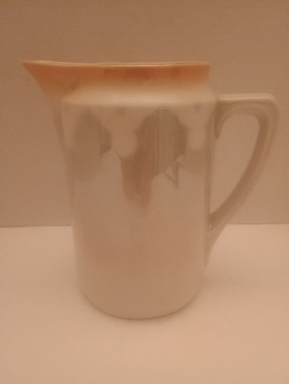 Neutral Ceramic Pitcher with Soft Peach Rim